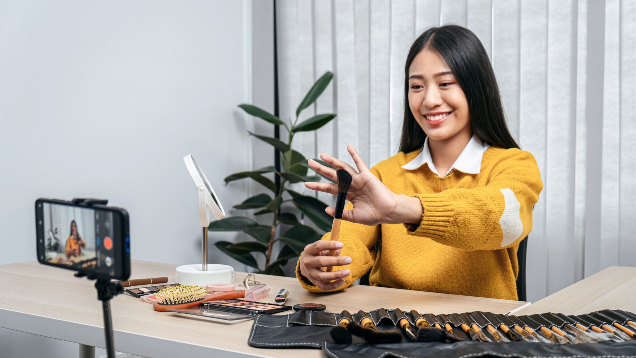 A female beauty influencer partners with a beauty PR agency to film a makeup brush review video