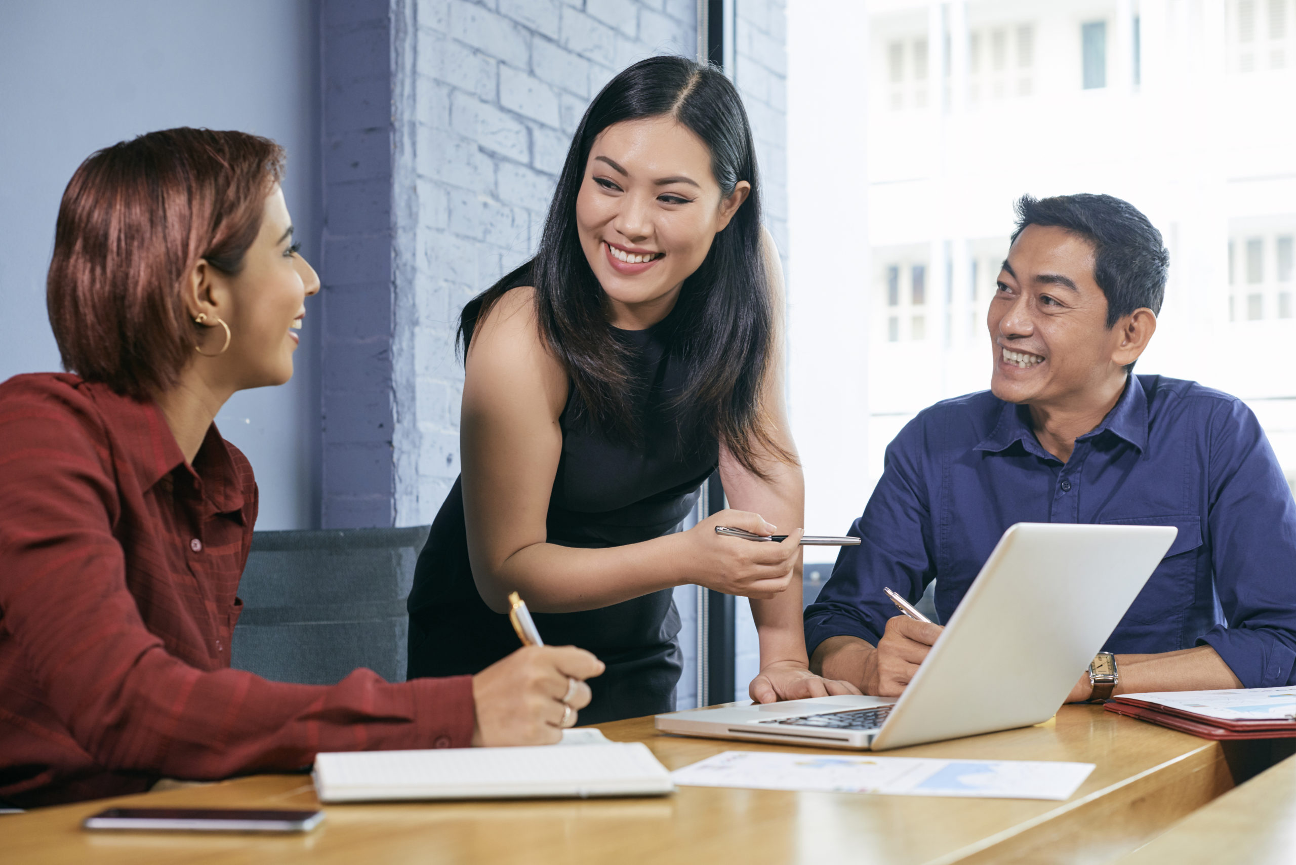 Female employee discussing with other coworkers
